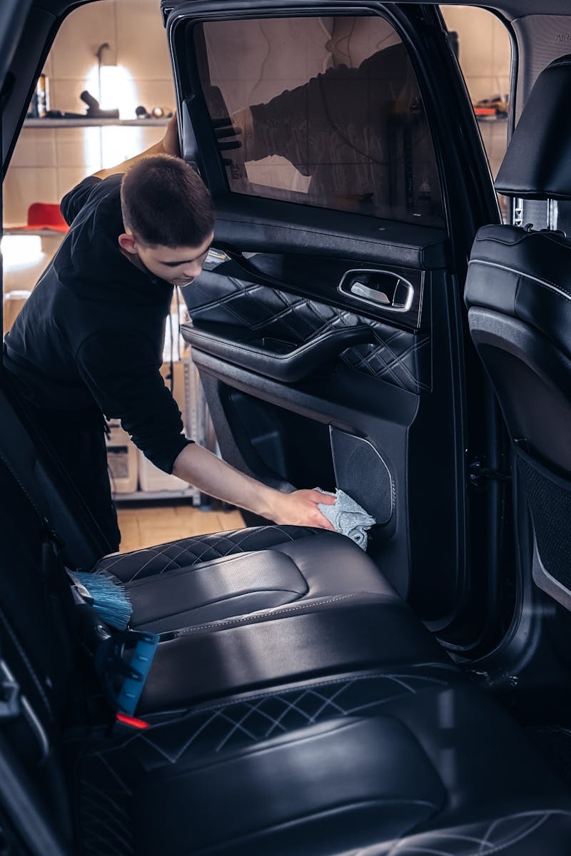 Professional car cleaning service in progress with focus on interior detailing for quality maintenance.