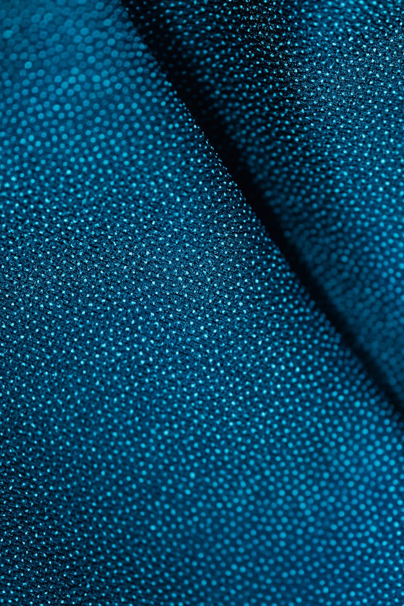 A detailed close-up shot of a blue textured fabric showing intricate patterns.